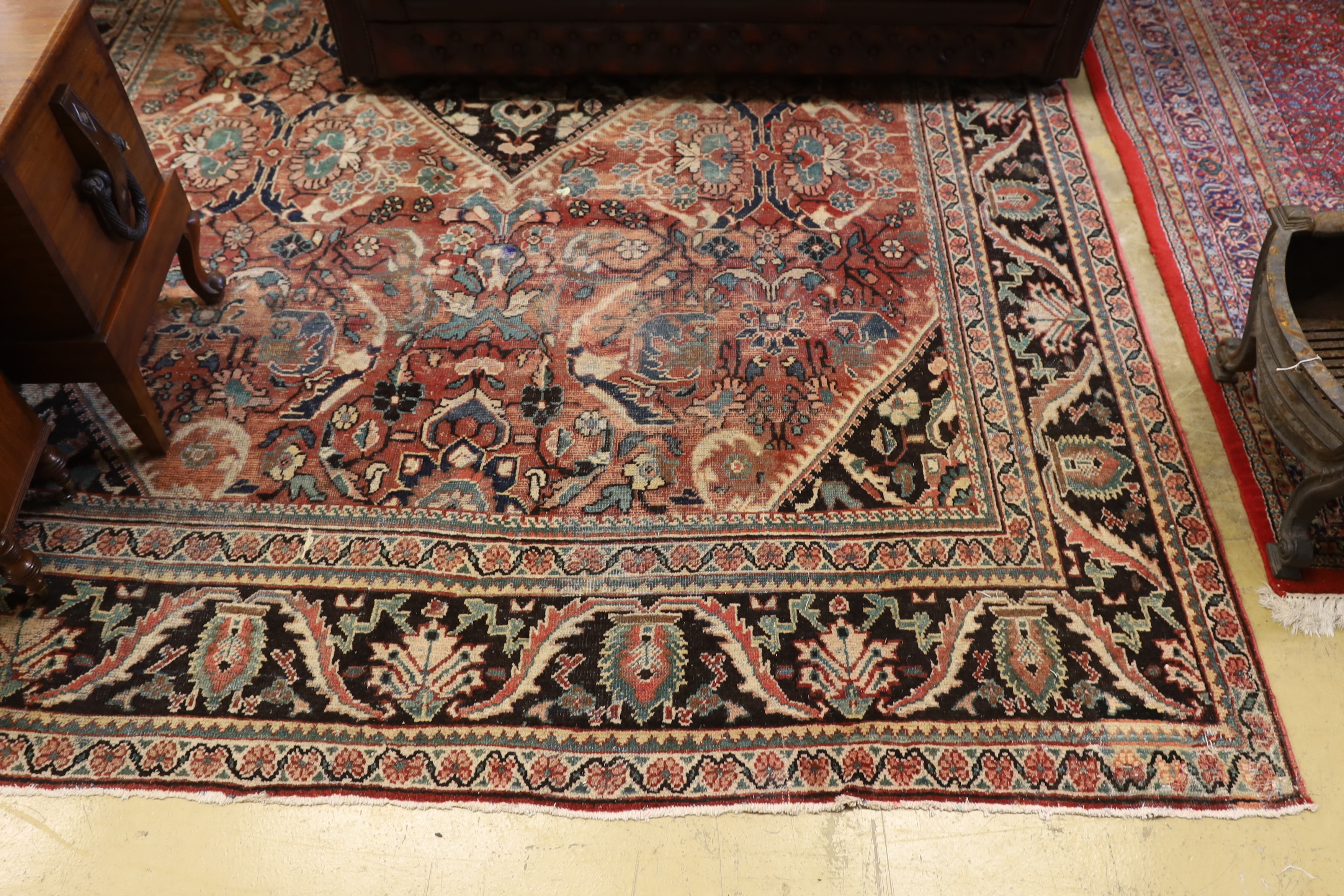 A Heriz brick red ground carpet, 370 x 280cm